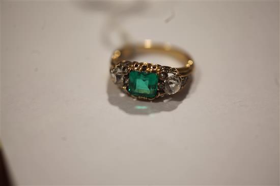 A 19th century gold, single stone emerald and two stone diamond ring, size M/N